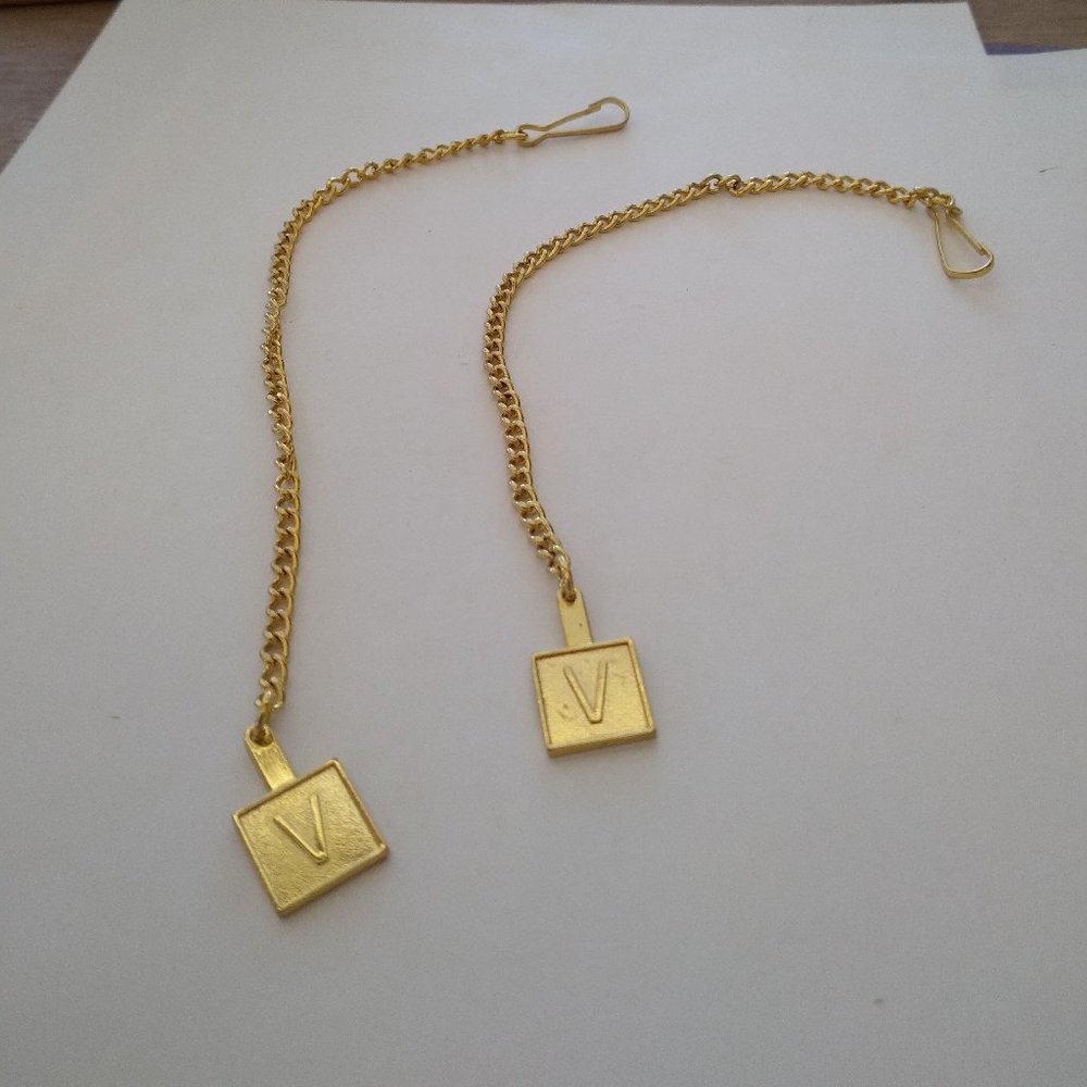 V and V Lettered gold tone imported Buttom hole clip pendant